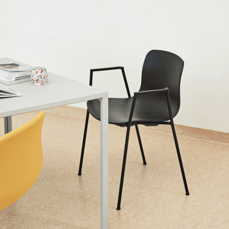 Black AAC 18 chair by HAY. Fully upholstered seat with slim, black legs and integrated armrests. Modern design.