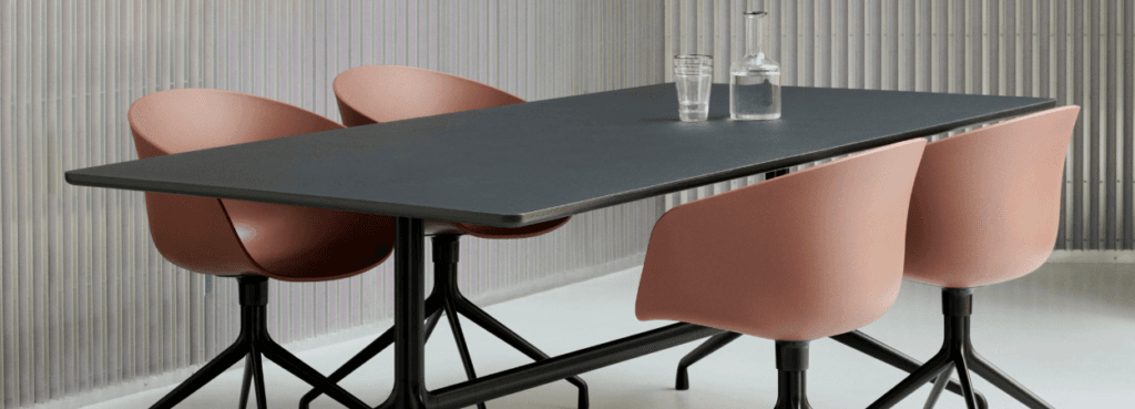 HAY AAC 20 chair with recycled shell and aluminum base, around a table.