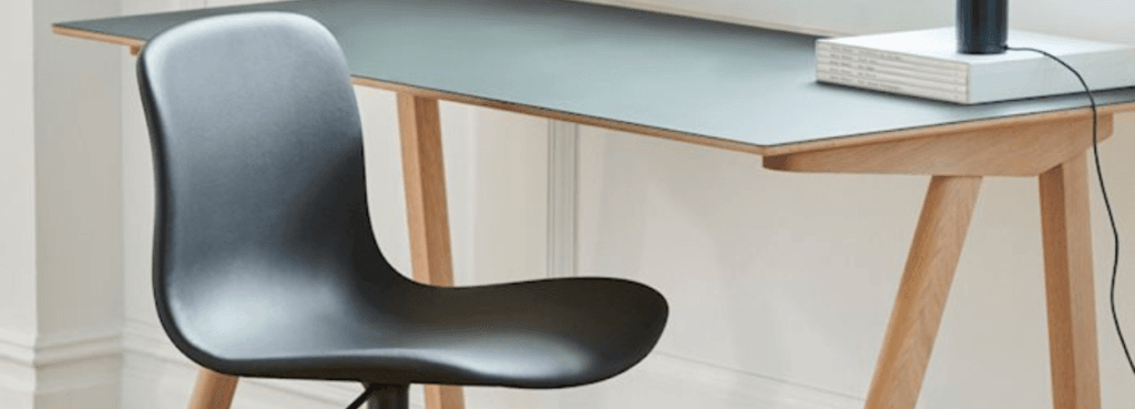 Modern office: HAY AAC 51 task chair in dark grey, with a sleek desk.