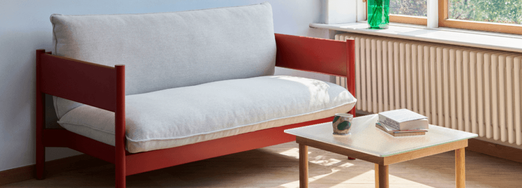 Modern Arbour Sofa Collection with red frame and light cushions. Scandinavian style seating for open spaces.
