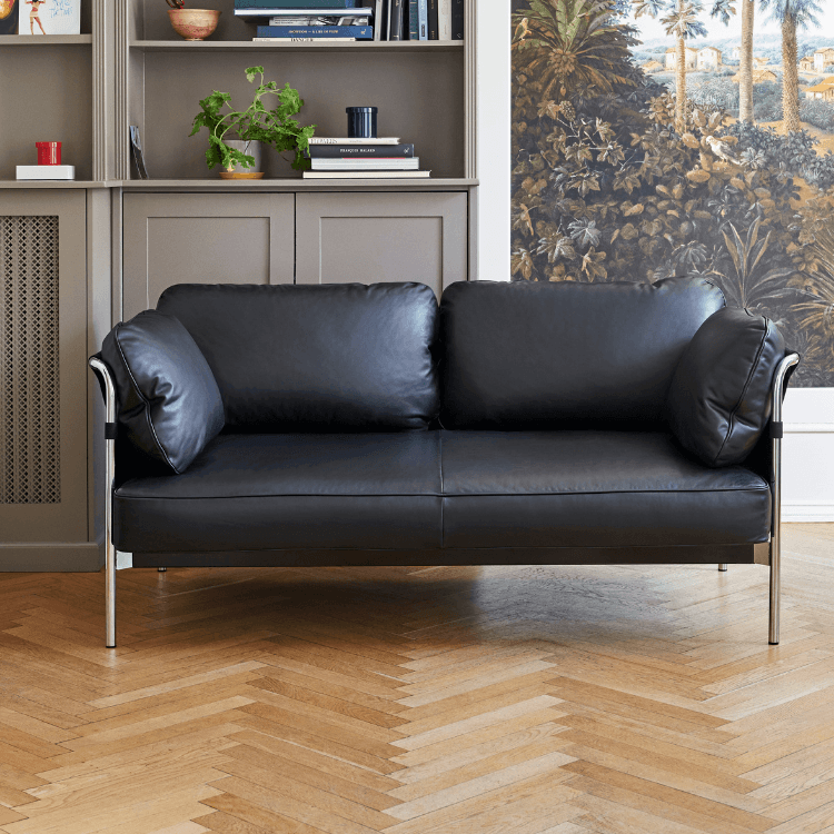 Modern black leather CAN Sofa by HAY with a sleek chrome frame.