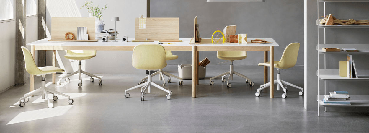 Muuto office furniture in Cyprus: Tables and chairs in a modern office setting.