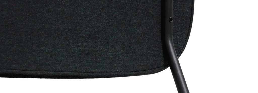 Close-up of Soft Edge 101 chair. Upholstered in dark fabric with black metal legs. Modern design.