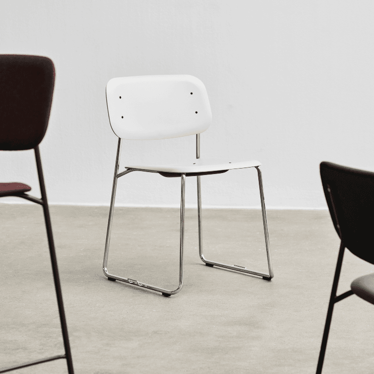 HAY Soft Edge 56 chair. White plastic seat/back, steel sled base. Modern, stackable design.