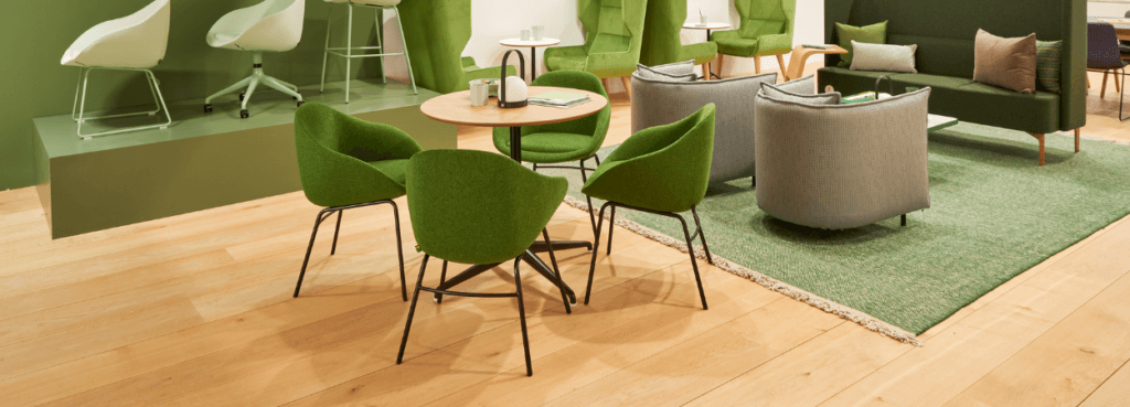 Workspace featuring green Always Chair seating around a table, plus sofa and chairs.