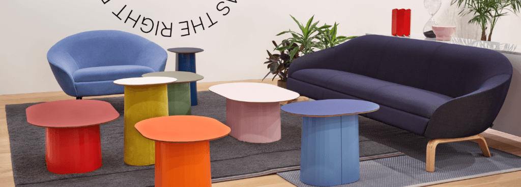 Modern interior featuring the NaughtOne Ever Sofa in blue with colorful side tables.