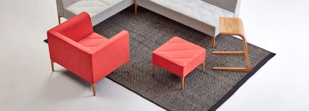 Modern red Hatch Lounge Chair and ottoman on a gray rug.