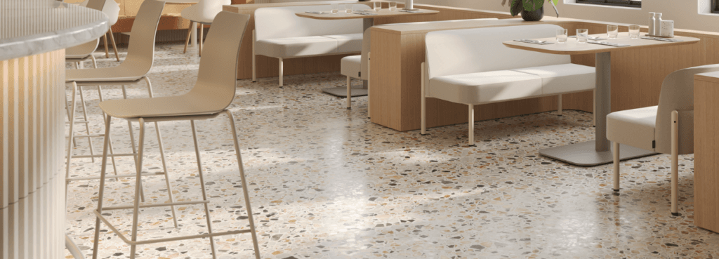 Modern interior with a light brown Ruby Stool, featuring a sleek design and metal frame, in a cafe setting.