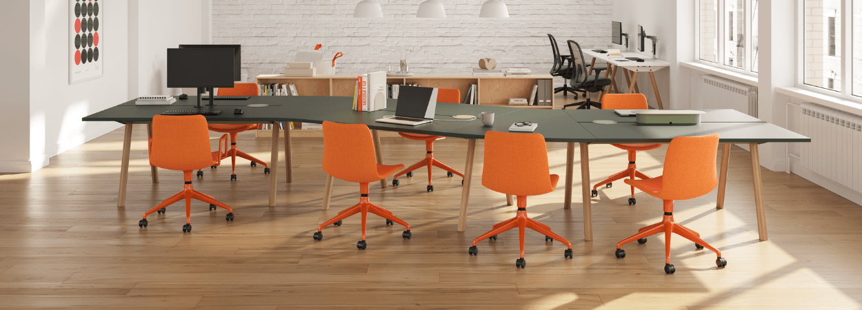 Office space featuring Viv chair, orange task chairs around a large green conference table. Modern office furniture.