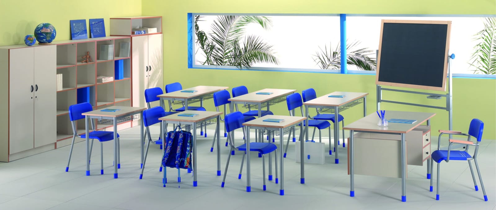 Classroom with collaborative furniture for 21st-century learning. Desks, chairs, blackboard, and storage units create a modern learning environment.