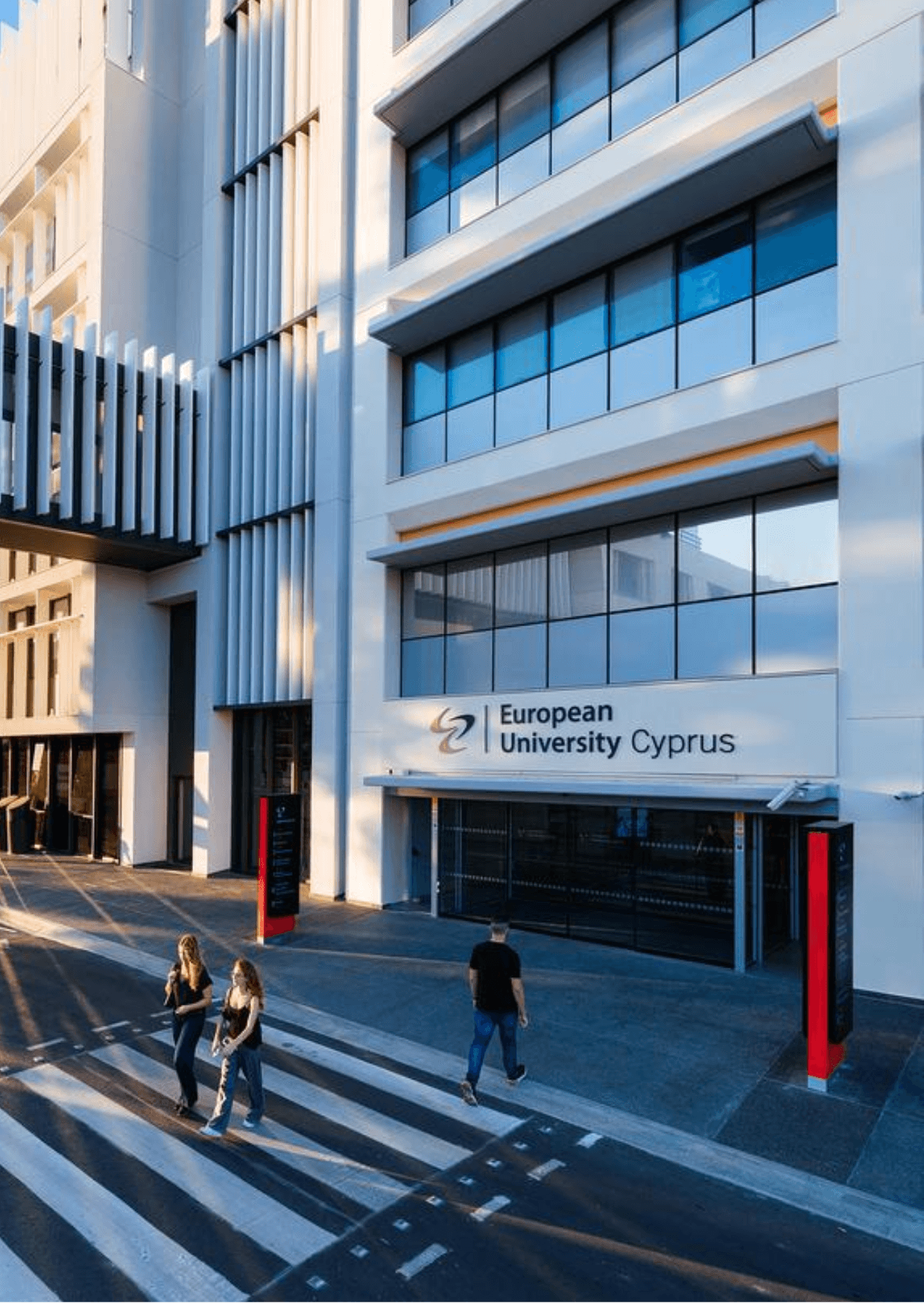 European University of Cyprus, Nicosia. Modern building with students crossing a zebra crossing. University of Cyprus campus view.