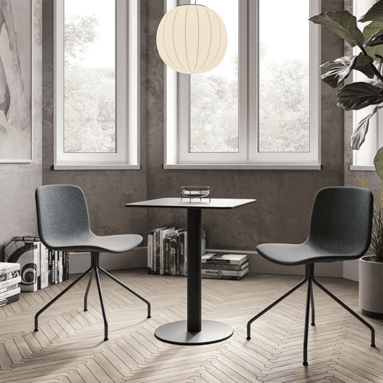 Modern gray Shade Table with two chairs. Square table with black pedestal base. Contemporary interior design.