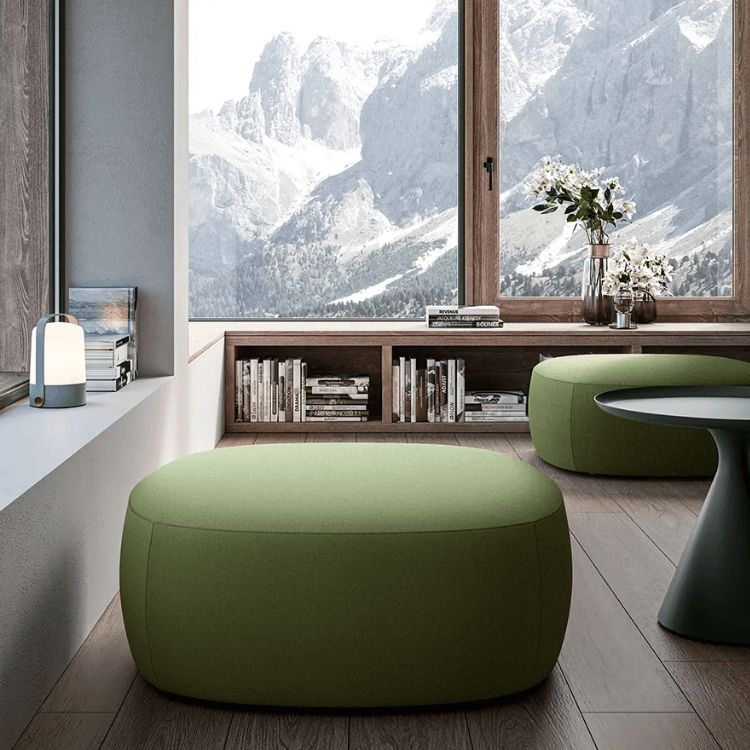 Stylish AUTO-DRAFT green ottoman seating in a modern living space with a mountain view.