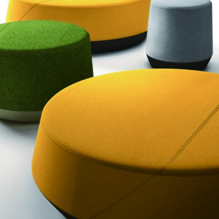 AUTO-DRAFT: Round, colorful ottomans in yellow, green, and gray. Modern seating for living spaces.