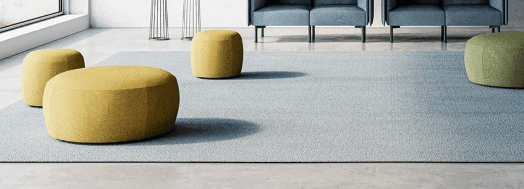 Contemporary AUTO-DRAFT carpet with yellow and green ottomans on a light gray floor. Modern, stylish design.