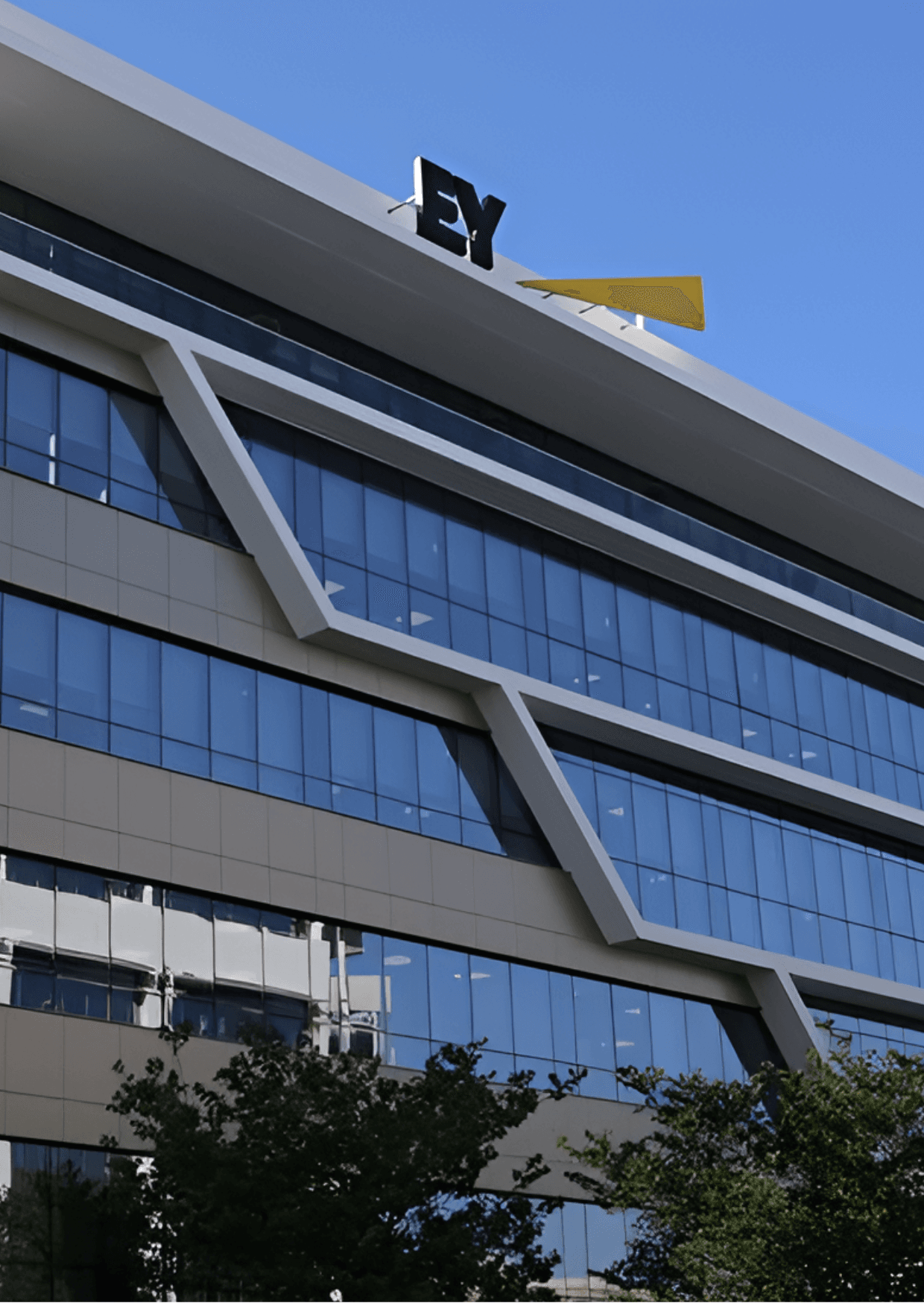 EY Nicosia, Cyprus office building featuring modern architecture with glass windows and the EY logo on top.
