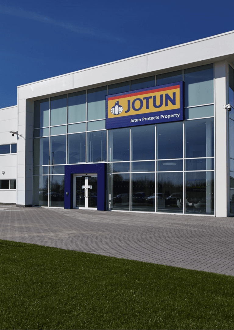 Jotun Paints building, Seeb, Oman. Modern architecture with Jotun logo, promoting property protection through quality paint solutions.