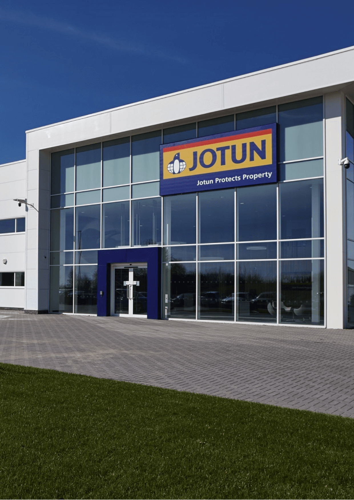 Jotun Paints building, Seeb, Oman. Modern architecture with Jotun logo, promoting property protection through quality paint solutions.