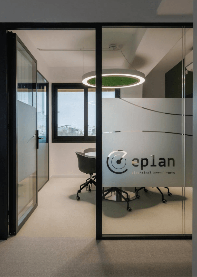 ePlan Consultants Cyprus office interior, showcasing a modern conference room with the 'ePlan' logo on frosted glass.