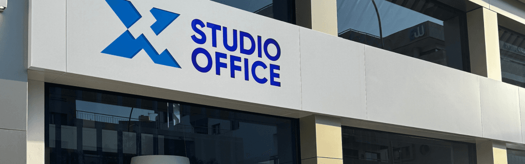 New Limassol office building featuring 'Studio Office' signage in blue on a white facade. Modern architecture.
