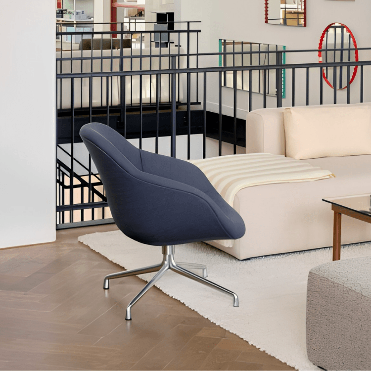 AAL 81 Soft swivel chair in dark fabric with a quilted front and silver four-leg star swivel base in a modern interior.