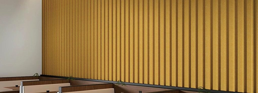 Mustard yellow 3D U-Channel Acoustic Panel with deep vertical fluted ridges installed on a wall above booth seating.