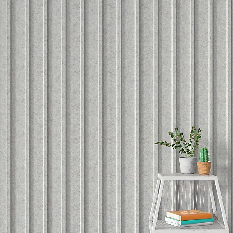 Light grey 3D U-Channel Acoustic Panel with felt texture, featuring vertical fluted lines behind a small plant and shelf.