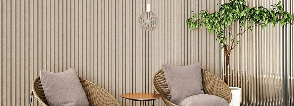 3D V-Groove Acoustic Panel in a modern room with vertical wall textures, wicker chairs, and a small side table.
