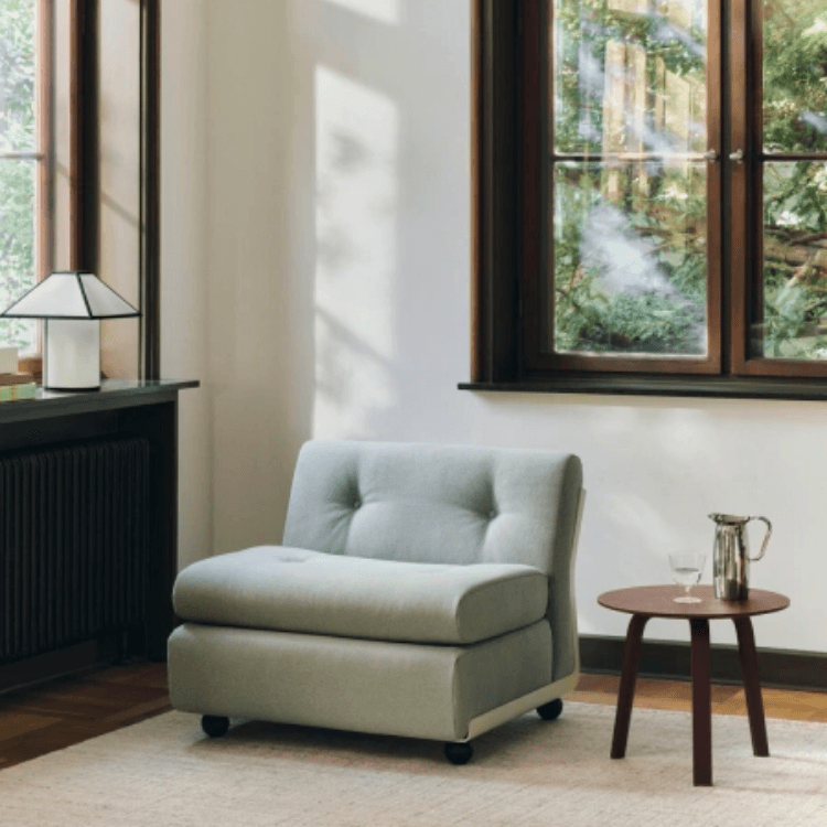 Amanta 1 Seater in soft green fabric, featuring a modular design with tufted backrest in a bright, modern interior.