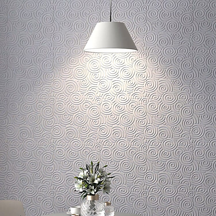 Close-up of Auspice Cloud grey PET felt wall tiles featuring a soft, sculptural spiral pattern under warm pendant light.