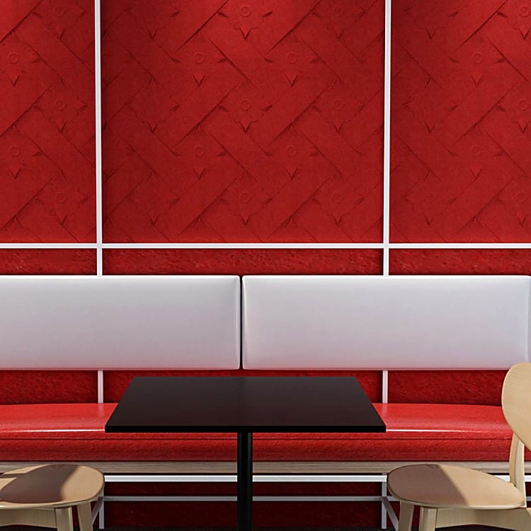 Deep red Babylon Relief acoustic panels featuring a woven lattice and decorative rosettes mounted on a wall.