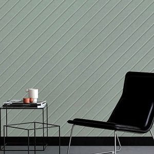 Close-up of a minty green Chevron Carved Acoustic Panel with clean diagonal grooves mounted on a modern wall.