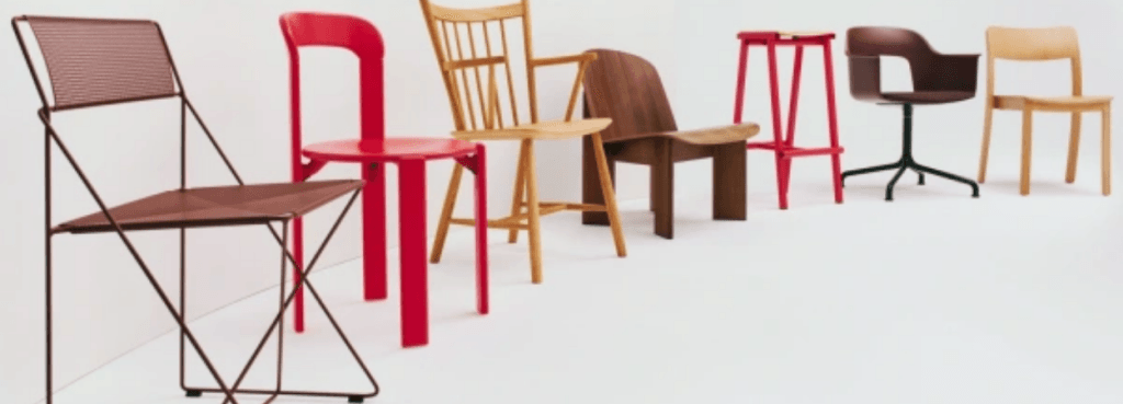 Chisel 85 Lounge Chair in dark wood displayed in a collection of diverse designer seating against a white backdrop.