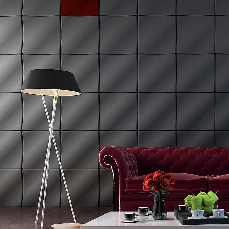 Crest & Trough dark grey modular wall panels creating a rhythmic undulating texture behind a velvet sofa.
