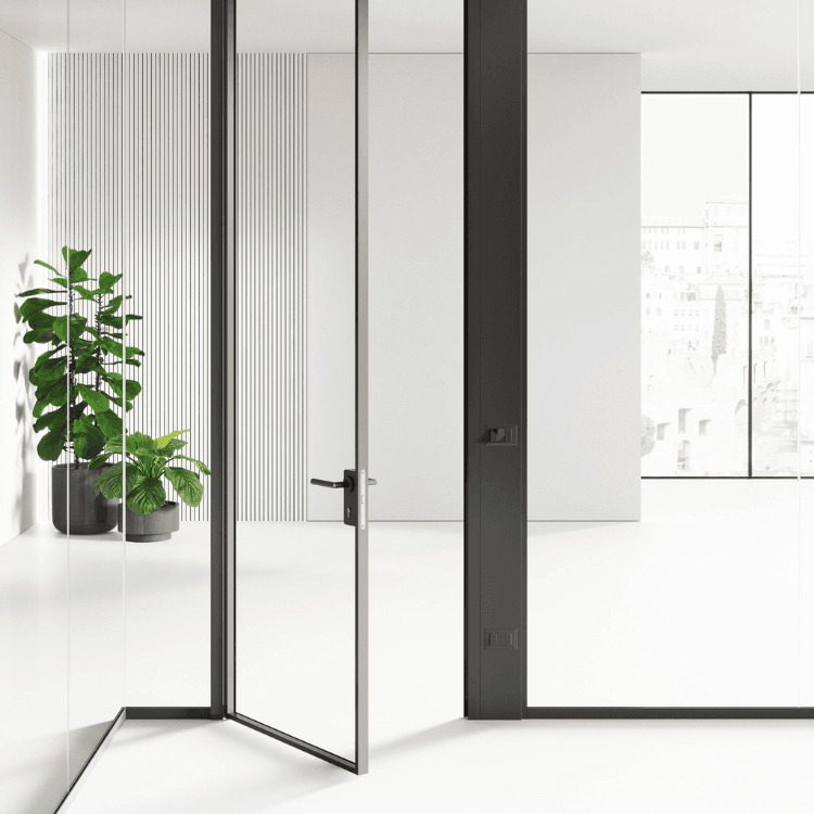 Modern glass-framed interior door with a sleek black metal handle in a bright, minimalist office space.