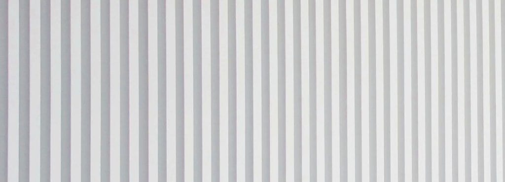 Close-up of a white Fine Reeded Acoustic Panel featuring uniform vertical ribs in a minimalist, modern style.