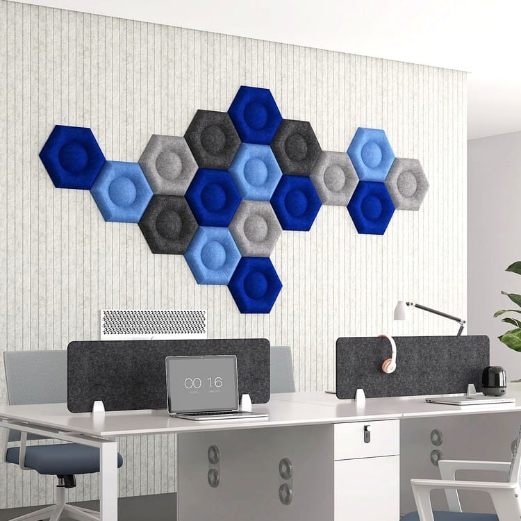 Hexa Core felt panels feature a recessed center, arranged in a modular honeycomb cluster on a vertical office wall.