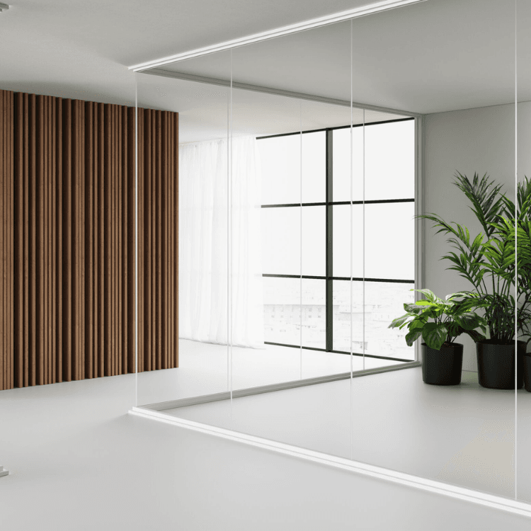 Infinity frameless glass partition system with wooden slat wall and minimalist modern interior design.