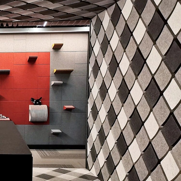 Keygrid Mini acoustic felt tiles create a dynamic, raised geometric texture on a modern interior wall.
