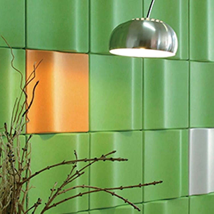 Litho Glow felt modules form a relief wall in lime, accented by a single orange panel and overhead metal pendant light.