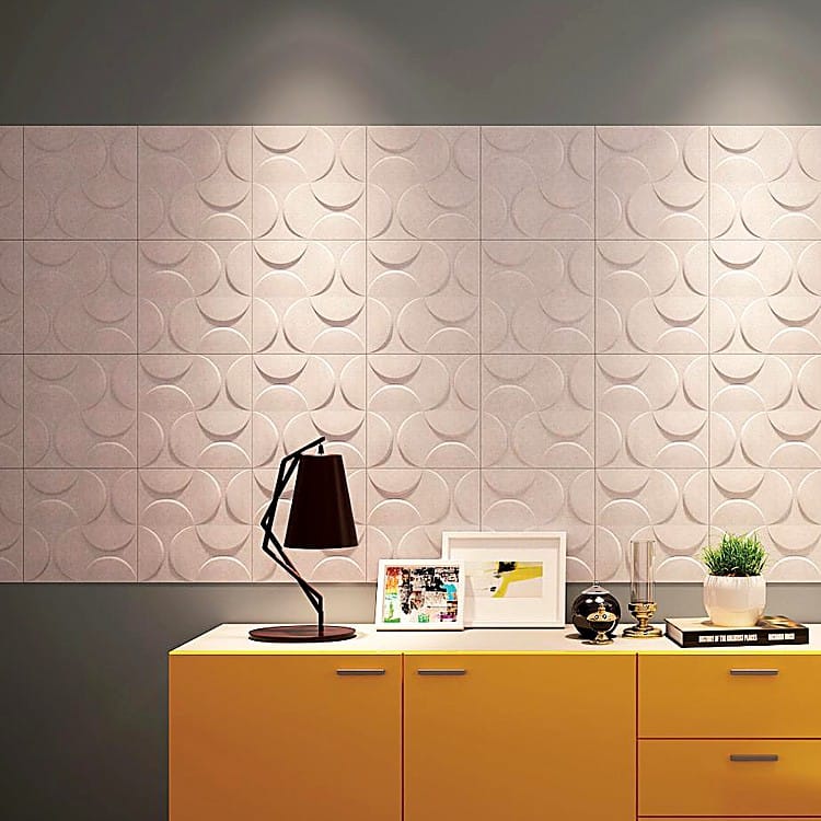 Lunar Crescent Big cream-colored acoustic wall panels featuring a recurring embossed moon and circle relief pattern.