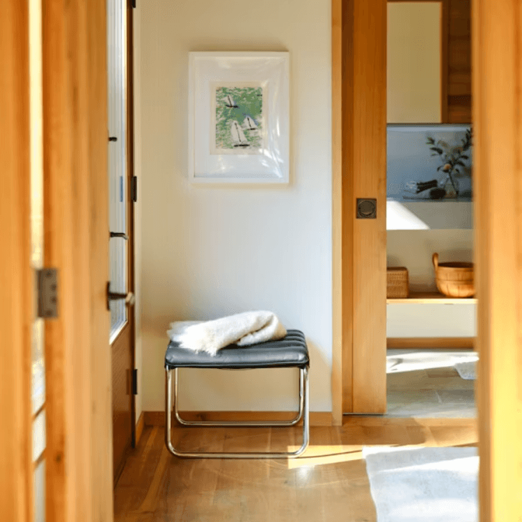 MR Stool with polished chrome tubular frame and black quilted leather cushion in a bright modern home entryway.
