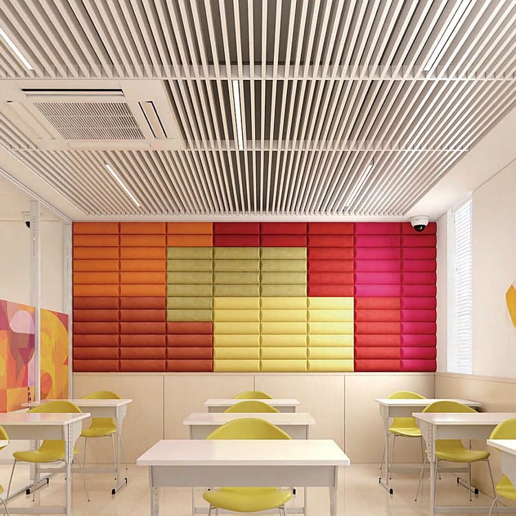 Multicolor Modu Rect acoustic felt panels arranged in a vibrant grid pattern on a classroom wall.