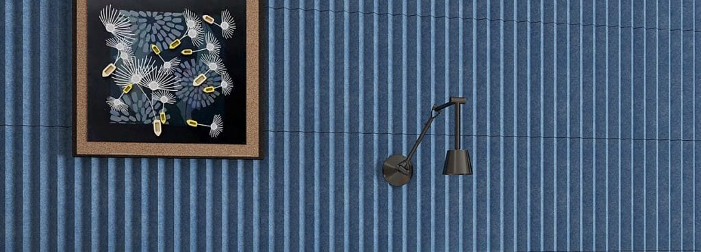 Blue Modu V acoustic wall panels featuring textured felt ridges with a V-shaped linear design.