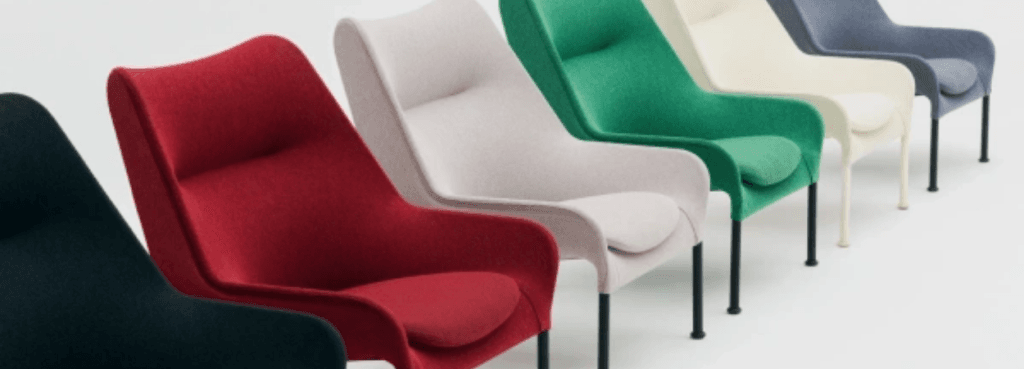 Five O2 Lounge Chairs in a vibrant spectrum of fabric hues lined up in a row against a seamless neutral backdrop.
