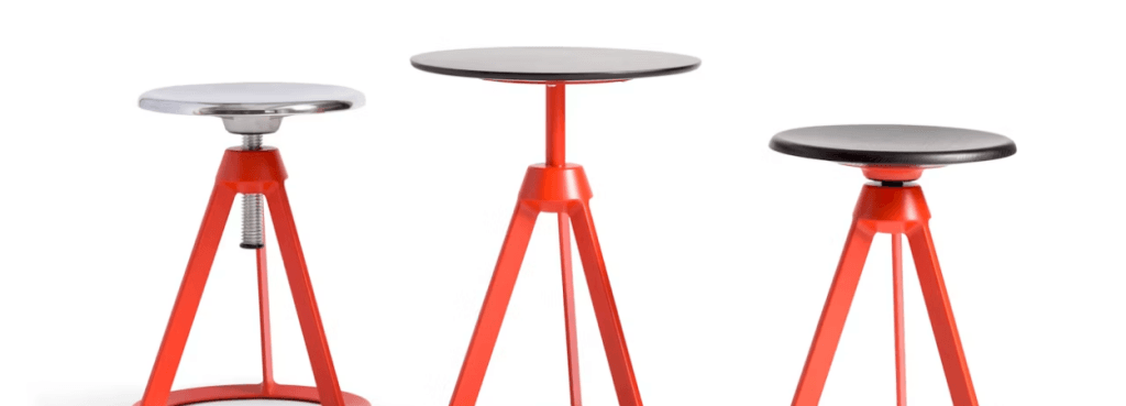 Group of vibrant orange Piton Stools with varying seat heights and materials set against a plain white backdrop.