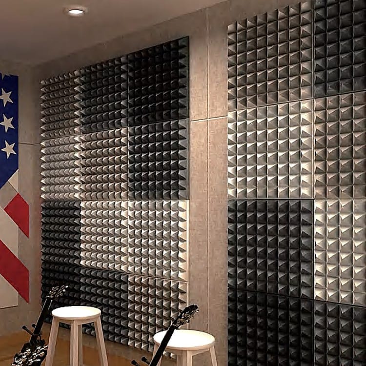 Textured Pyramid acoustic panels in charcoal and silver arranged on a wall to reduce room echo.