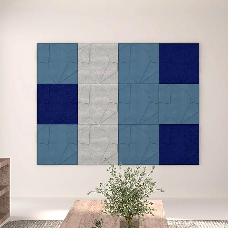 Rhythmic Layer panels form a modern wall mosaic with contrasting blue and grey tilted geometric felt surfaces.