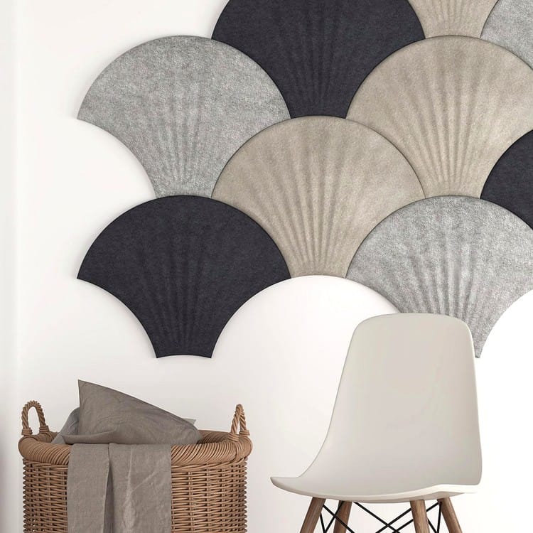 Seashell Ripple felt wall tiles featuring a radiating rib design in charcoal, sand, and light gray layered on a wall.