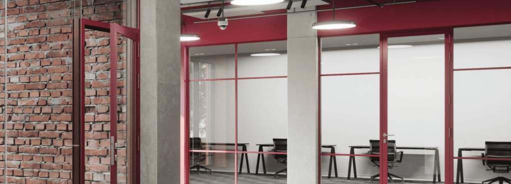 Silence Loft Fire-Resistant System installed in a modern office, featuring red frames against a rustic brick wall.